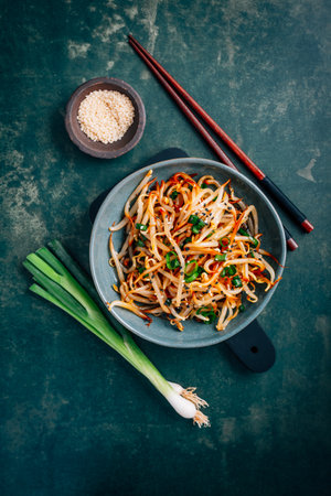 Spicy mung bean sprouts salad with garlic, sesame seeds, green onions, soy sauce, spices and red pepper. Kongnamul Muchim. Traditional Korean dish.の写真素材