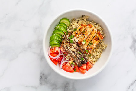 Healthy bowl with cauliflower rice, enoki mushrooms, chicken and vegetables. Keto/Paleo diet menu, low carb.の写真素材