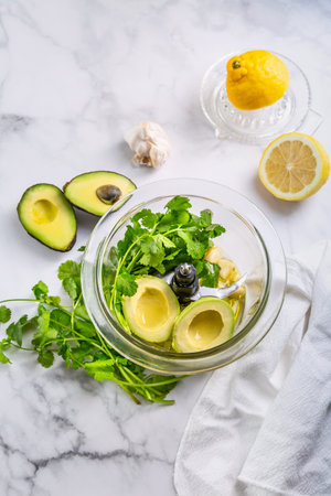 Preparing homemade avocado dressing or dip in food processor.の写真素材