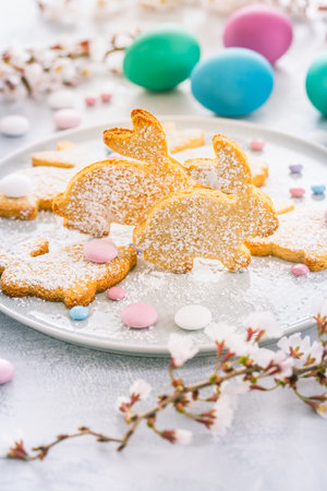 Homemade almond bunny cookies for Easter with colorful Easter eggs