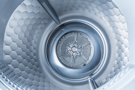 Inside of tumble dryer with clean laundry - new generation of heat pump dryer, household conceptの写真素材