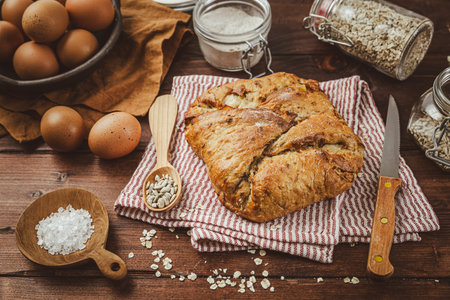 Oatmeal and potato bread on kitchen table in brown tone
