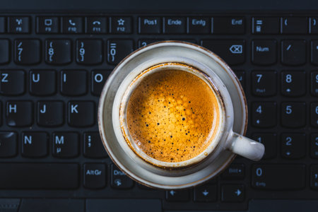 Coffee break in an office, cup of espresso in an office. Workplace in a coffee shop or home office