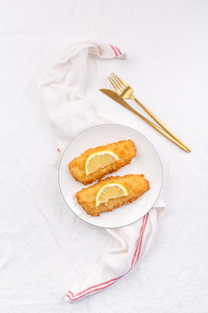 Crispy breaded fish with dipping sauce and lemon