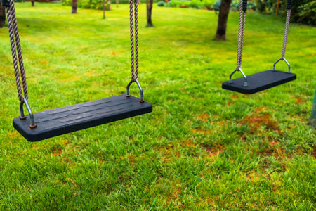 Children swing in an empty park or garden