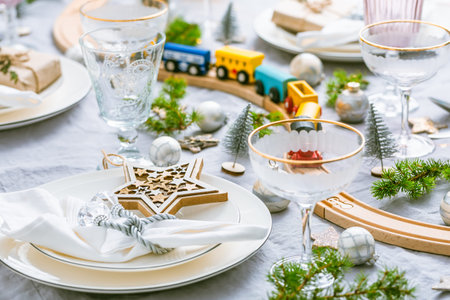 Traditional festive place setting for Christmas, decorated with wooden railways