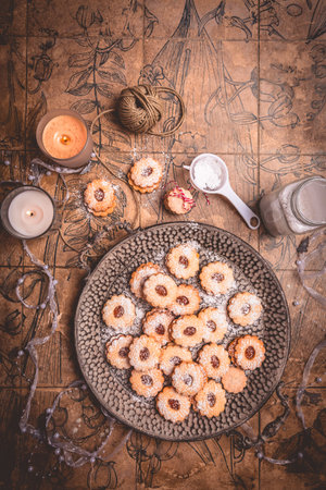 Homemade Christmas cookies on kitchen table with candles