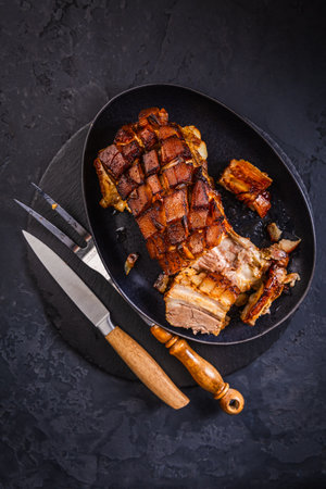 Crispy baked pork belly on black backgroundの写真素材