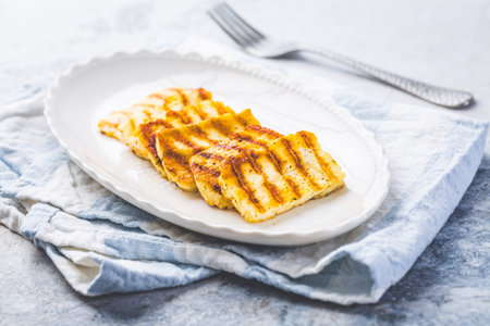 Grilled halloumi cheese on serving plateの写真素材