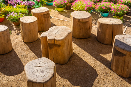 Cozy seating area in a garden or patio made from natural wooden logsの写真素材