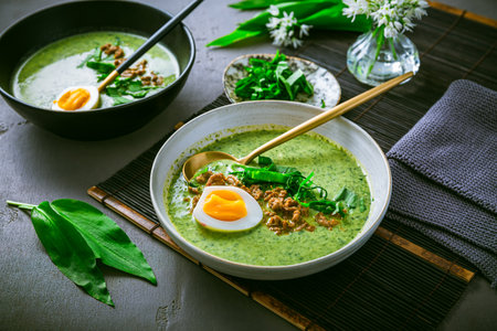 Wild garlic soup, bear leek soup (ramson soup) with boiled eggの写真素材