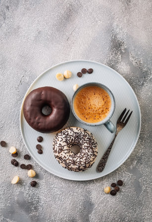 Glazed donuts with coffee on kitchen tableの写真素材