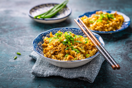 Indian Biryani, popular Indian rice dish served in small bowls with green onionsの写真素材