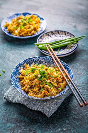 Indian Biryani, popular Indian rice dish served in small bowls with green onionsの写真素材