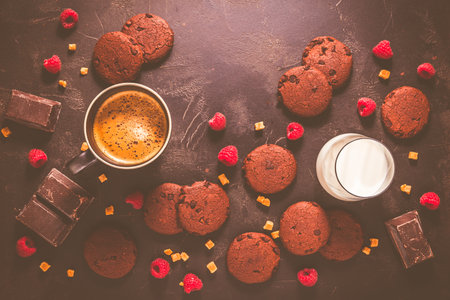 Cup of hot coffee and chocolate cookies for breakfast  or snack on wooden tableの写真素材