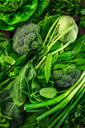 Green organic vegetables and dark leafy food background as a healthy eating concept of fresh garden produceの写真素材