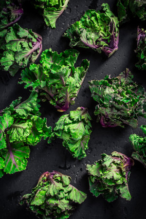 kale sprouts, flower sprouts on black background. Hybrid plant, cross between kale and Brussels sprouts, healthy winter vegetable.の写真素材