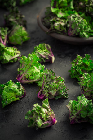 kale sprouts, flower sprouts on black background. Hybrid plant, cross between kale and Brussels sprouts, heathy winter vegetable.の写真素材