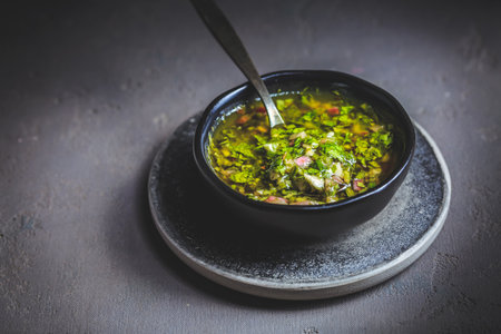 Chimichurri verde - traditional Argentine condiment, made from finely chopped parsley, minced garlic, olive oil, oregano, and wine vinegarの写真素材