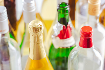 Full and empty bottles of different alcoholic drinks.の写真素材