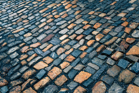 The pavement of granite stone. Paved roadway street, texture, background, selective focus.の写真素材