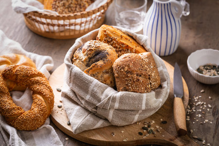 Assortment of bread, rolls and bakery products with salt, butter and seedsの写真素材