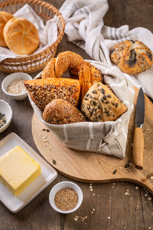 Assortment of bread, rolls and bakery products with salt, butter and seeds