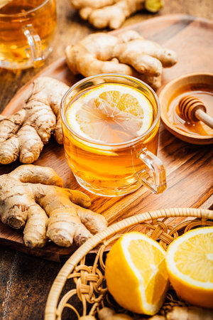 Ginger tea with lemon and honey on a wooden tableの写真素材