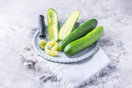 Removing seeds from cucumbers, preparing for stuffingの写真素材