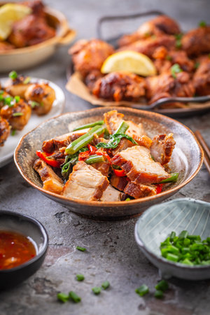 Assortment of Asian street food, stir fry with vegetables, chicken wings, meat balls and riceの写真素材