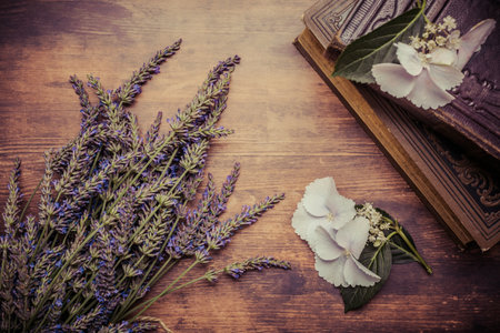Vintage background with bunch of lavender and old books on wooden backgroundの写真素材