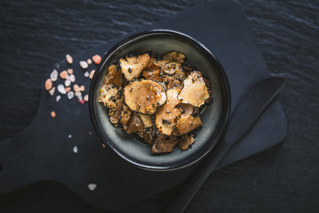 Rustic still life with truffles, truffle oil and salt on a wooden table, showcasing gourmet ingredients and culinary toolsの写真素材