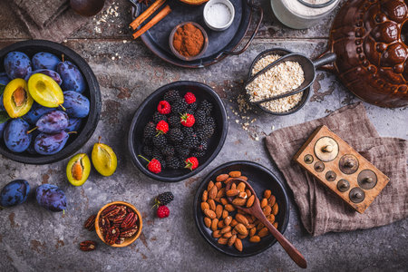 Freshly picked berries and plums with healthy baking ingredientsの写真素材