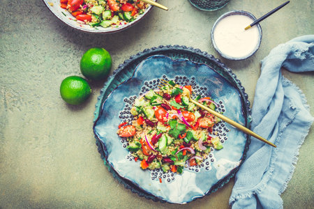 Healthy quinoa black bean salad with fresh tomatoes, cucumbers, onion and cilantroの写真素材