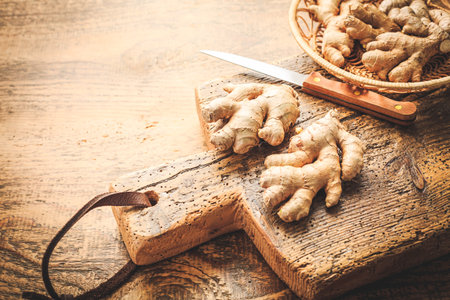 Fresh organic ginger roots on wooden background.の写真素材