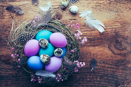 Happy Easter - nest with Easter eggs on wooden background with copy spaceの写真素材