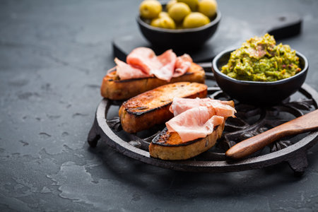 Fried bread, substitute for toast, savory French toast with avocado spread and Serrano hamの写真素材