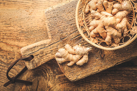 Fresh organic ginger roots on wooden background.の写真素材