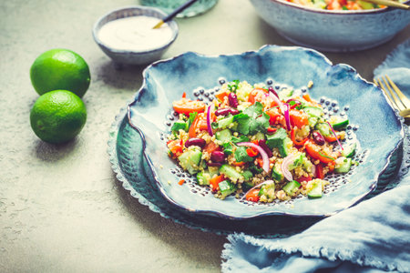 Healthy quinoa black bean salad with fresh tomatoes, cucumbers, onion and cilantroの写真素材