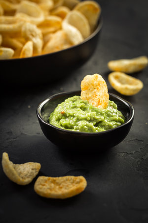 Fried shrimp cracker in Thai style. Shrimp cracker with avocado dip on wooden backgroundの写真素材