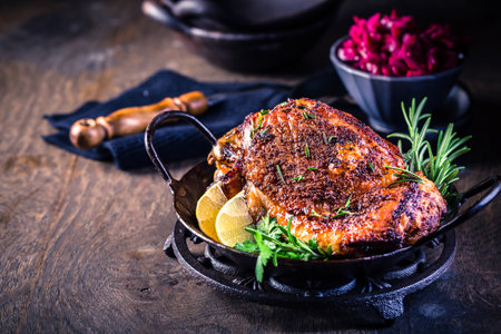 Roasted turkey knuckle with pickled red cabbage salad on wooden backgroundの写真素材