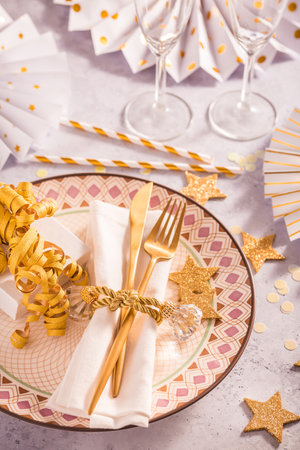 Festive place setting for Christmas and New Year with paper  fans in golden toneの写真素材