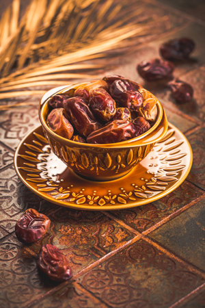 Dried  organic dates in bowl on old kitchen tableの写真素材