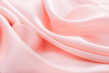 Smooth elegant pink silk or satin texture can use as wedding background. Luxurious background design. Soft focusの写真素材