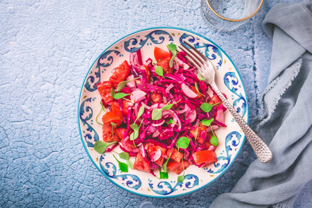 Winter salad - pickled red cabage salad with radish, tomatoes, onion and  winter purslane. Vegetarian healthy food.の写真素材