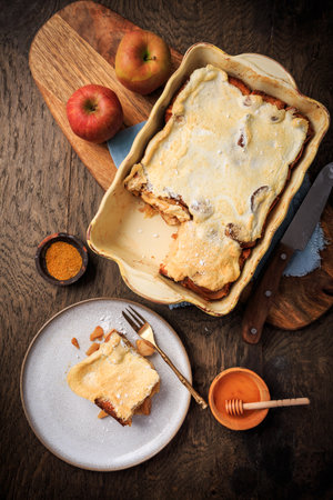 Homemade bread pudding breakfast casserole with apples and cinnamon and egg white frostingの写真素材