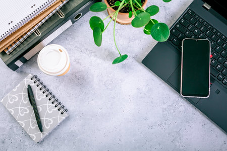 Modern office desk table with laptop, smartphone and other supplies with cup of coffeeの写真素材