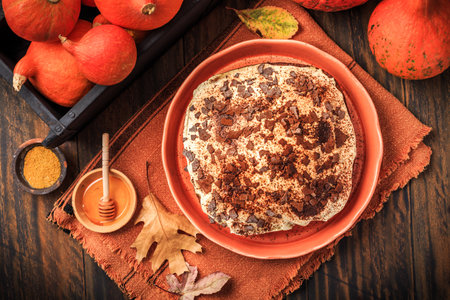 Homemade pumpkin cake with apples and fresh cheese icingの写真素材