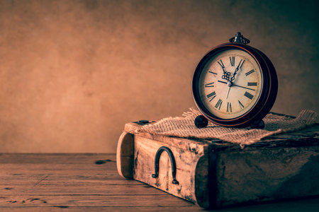 Vintage alarm clock with copy space. Photo in retro color image styleの写真素材