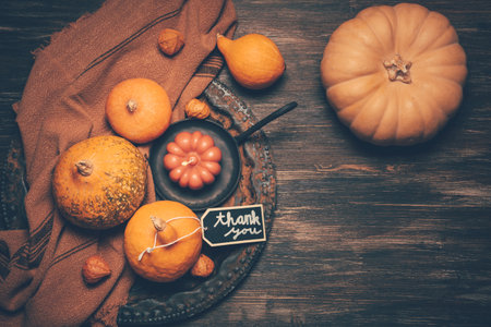 Happy Thanksgiving Day background, wooden table decorated with Pumpkins and Candlesの写真素材